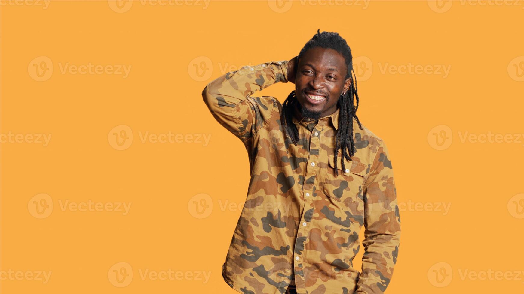 Portrait of young adult being confused in studio, thinking about something and feeling sceptic. African american uncertain man contemplating and being unsure on camera, reflection concept. photo