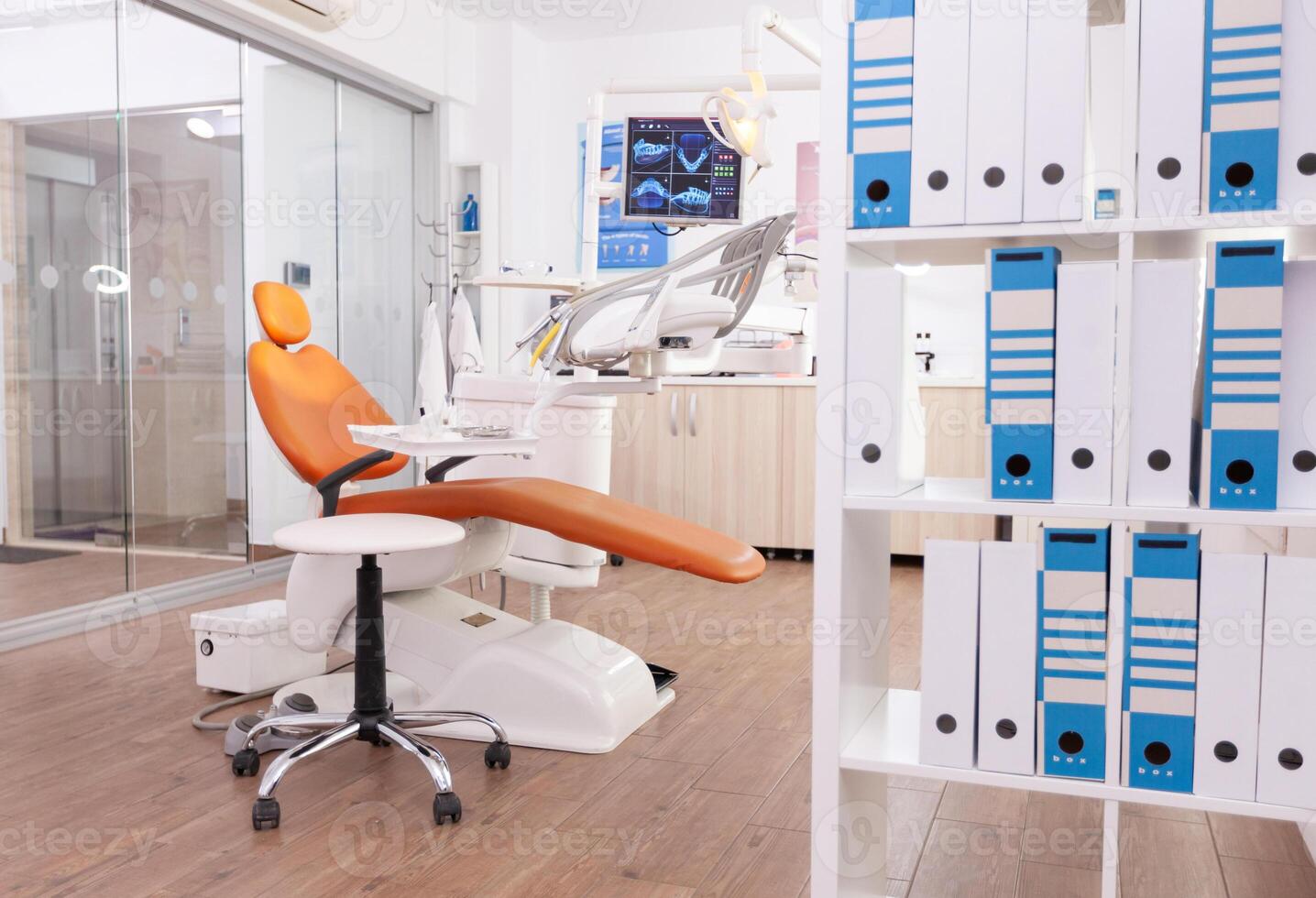 Empty stomatology orthodontic office room with nobody in it equipped with professional medical dental teeth instruments prepared for dentistry health surgery. Cabinet ready for tooth surgery photo