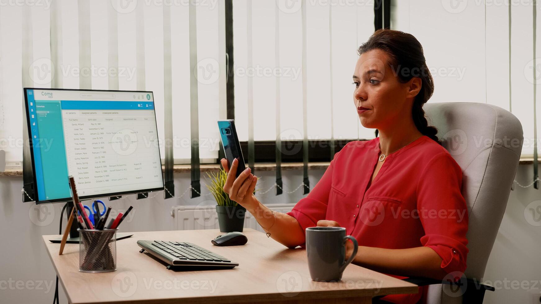 Having conversation on webcam using phone in office room. Freelancer working with business remotely team discussing chatting having online conference, webinar with internet technology photo