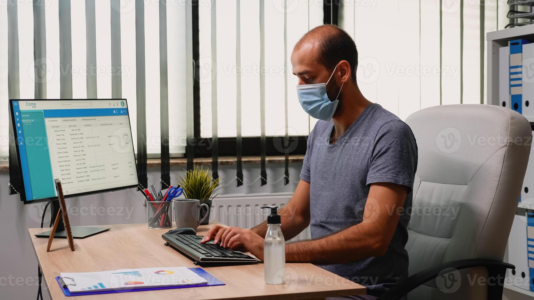 Worker wearing protection mask using sanitiser gel during coronavirus. Entrepreneur working in new normal office workplace in company cleaning hands using antibacterian alcohol against corona virus. photo