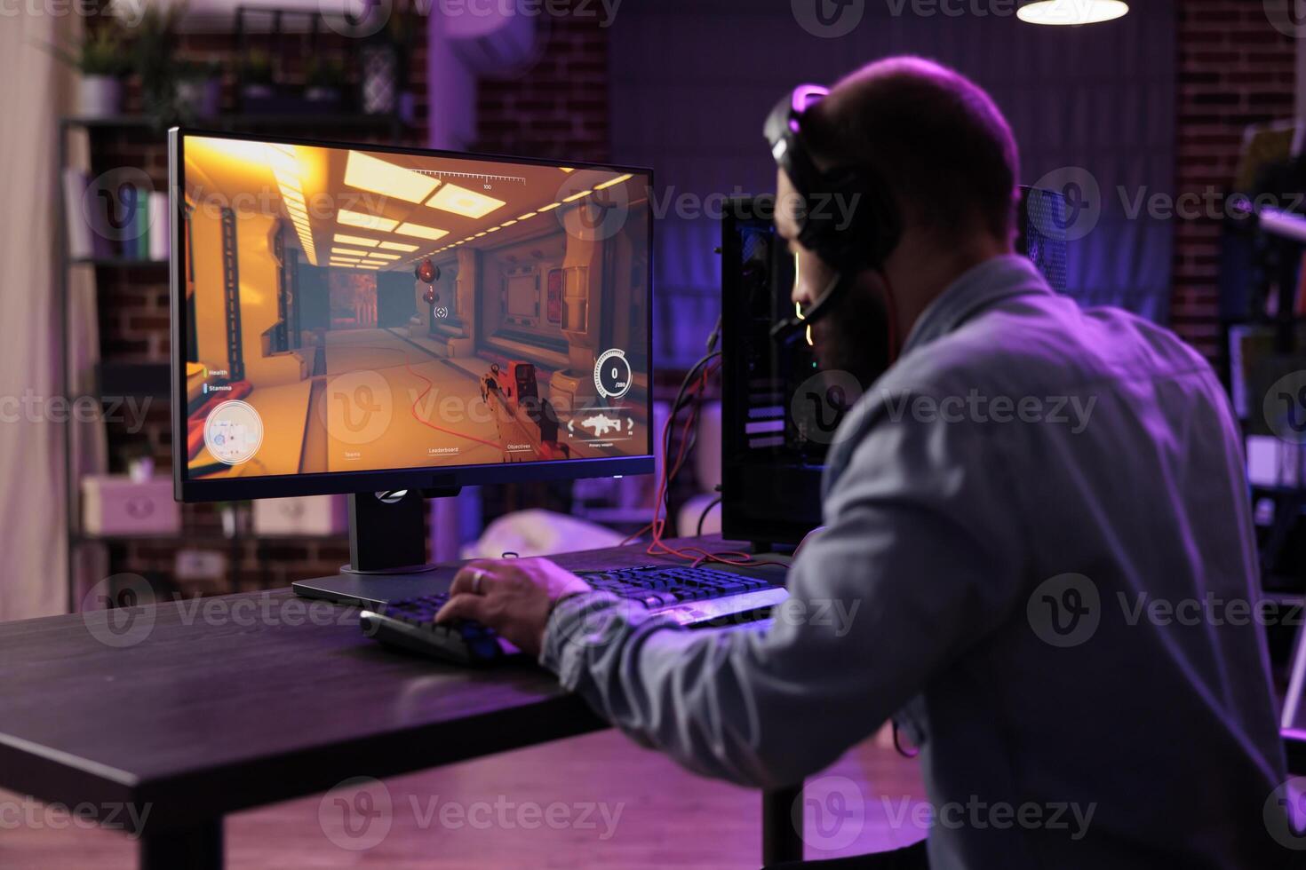 Experienced gamer competing in intense online multiplayer videogame, broadcasting esports tourney live from brick wall apartment. Man using expert level gaming mouse and keyboard, preventing input lag photo