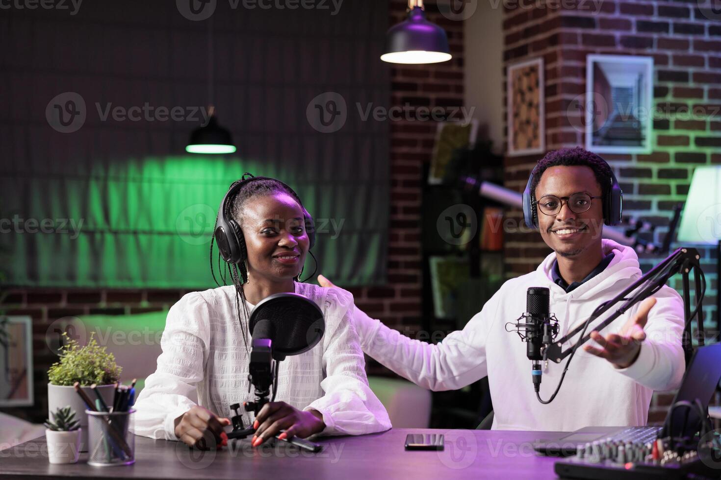 Team of content creators hosting online show in home studio, filming vlog, producing social media content. Vloggers recording episode for streaming service channel, entertaining audiences photo