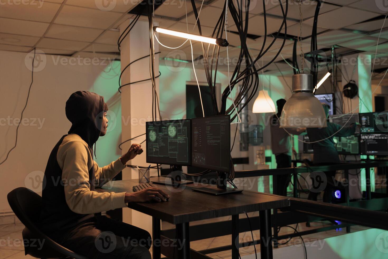 Spy committing cyberattack and stealing important information, causing data breach with malware. Internet criminal hacking computer system and programming trojan virus, coding at night. photo
