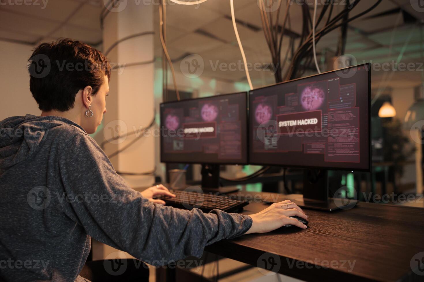 Female spy hacking computer system with trojan virus, stealing privacy data and creating malware. Young hacker coding malicious software and breaking into government database. Back view. photo