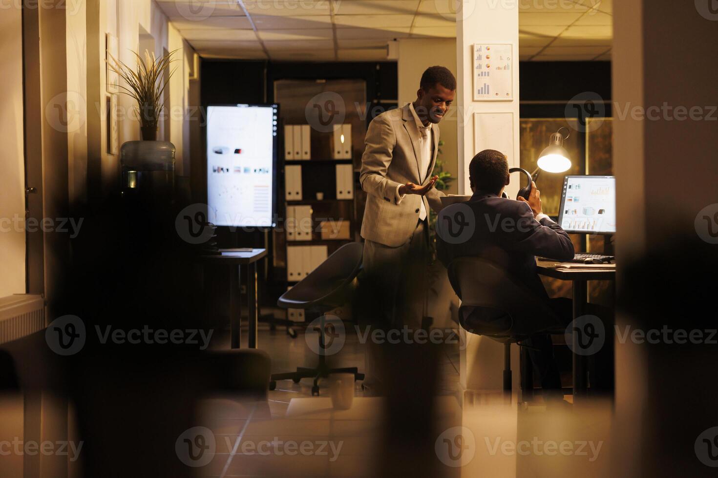 Marketing department employee discussing company strategy, working overtime at financial report statistics. Manager and businessan planning company investment plan. Business concept photo