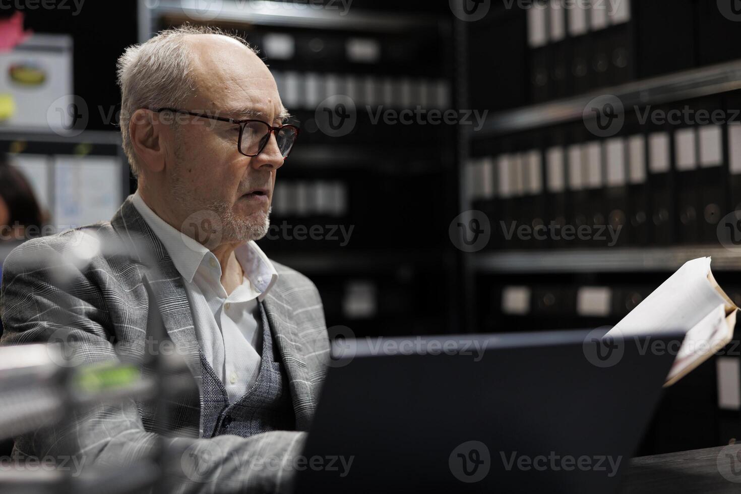 Accountancy businessman checking bookkeeping analytical data paperwork. Administration employee in business company file cabinet repository filled with flowcharts and folders photo