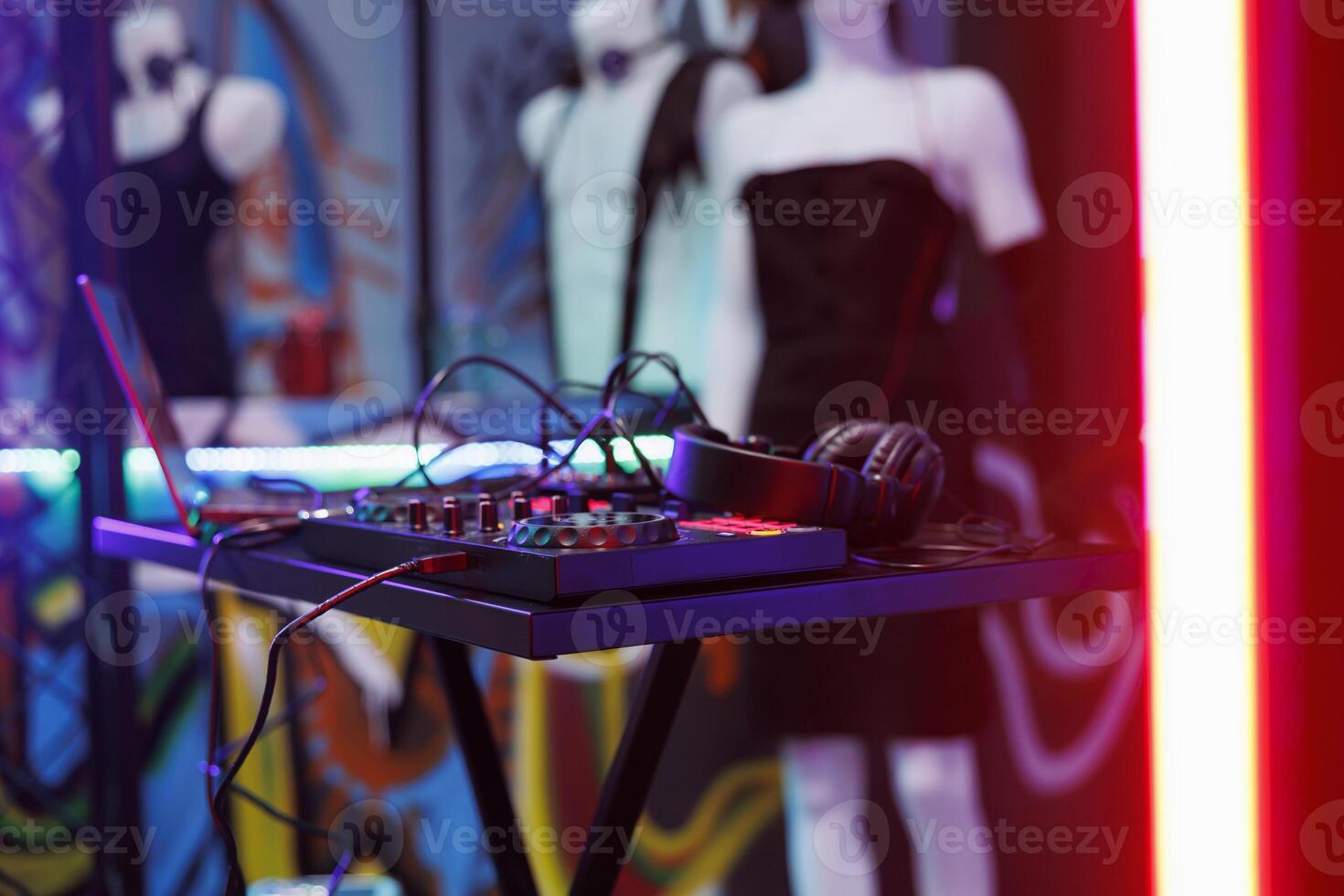 Dj music mixer equipment live concert and discotheque at nightclub stage. Musician controller for sound and volume mixing and headset for live performance in club with spotlight glow close up photo