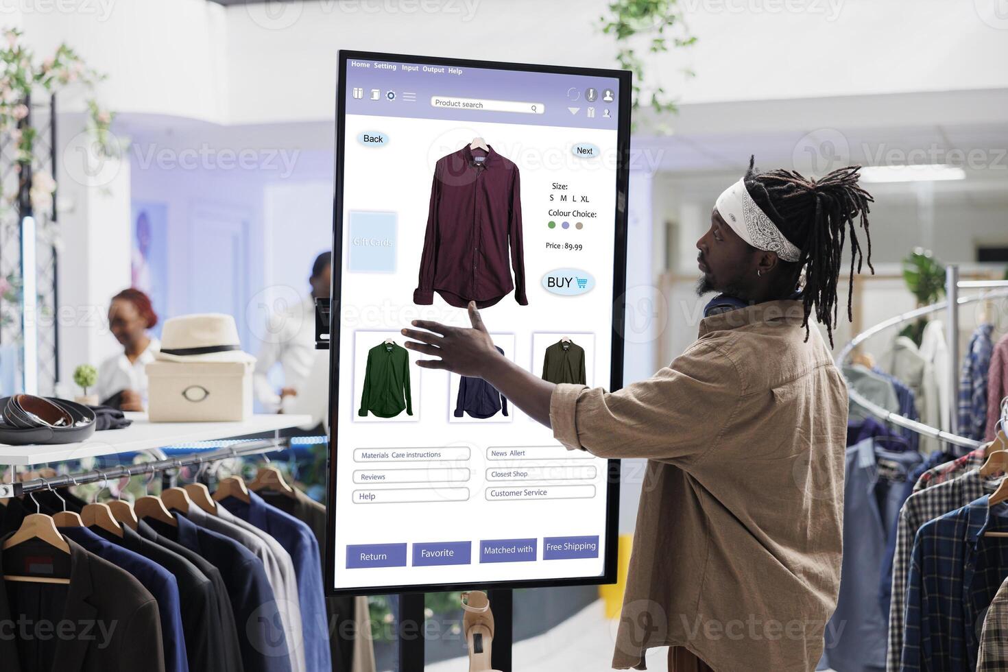 African american client selects clothes on touch screen board in clothing store, buying items from self service checkout kiosk. E commerce self ordering concept in fashion boutique. photo