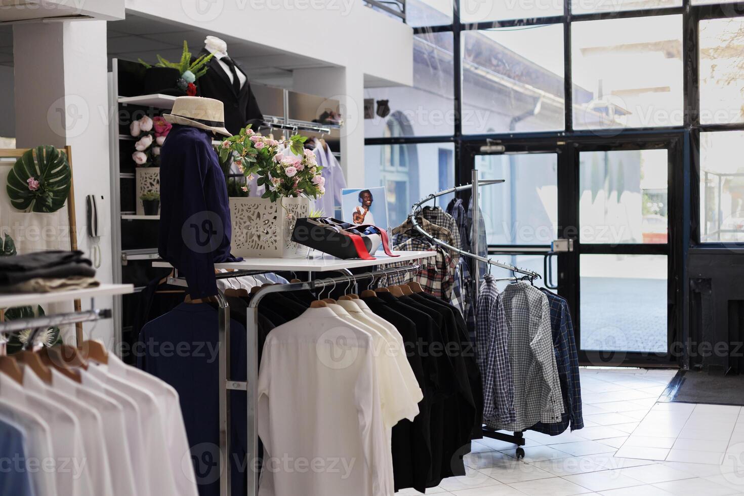 Empty modern boutique filled with racks and hangers, casual wear items hanging in fashion store boutique. fashionable clothes and accessories on discount, small business commercial activity. photo