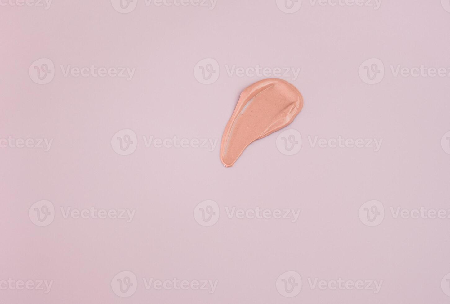 close-up of a smear of foundation on a pink background. photo
