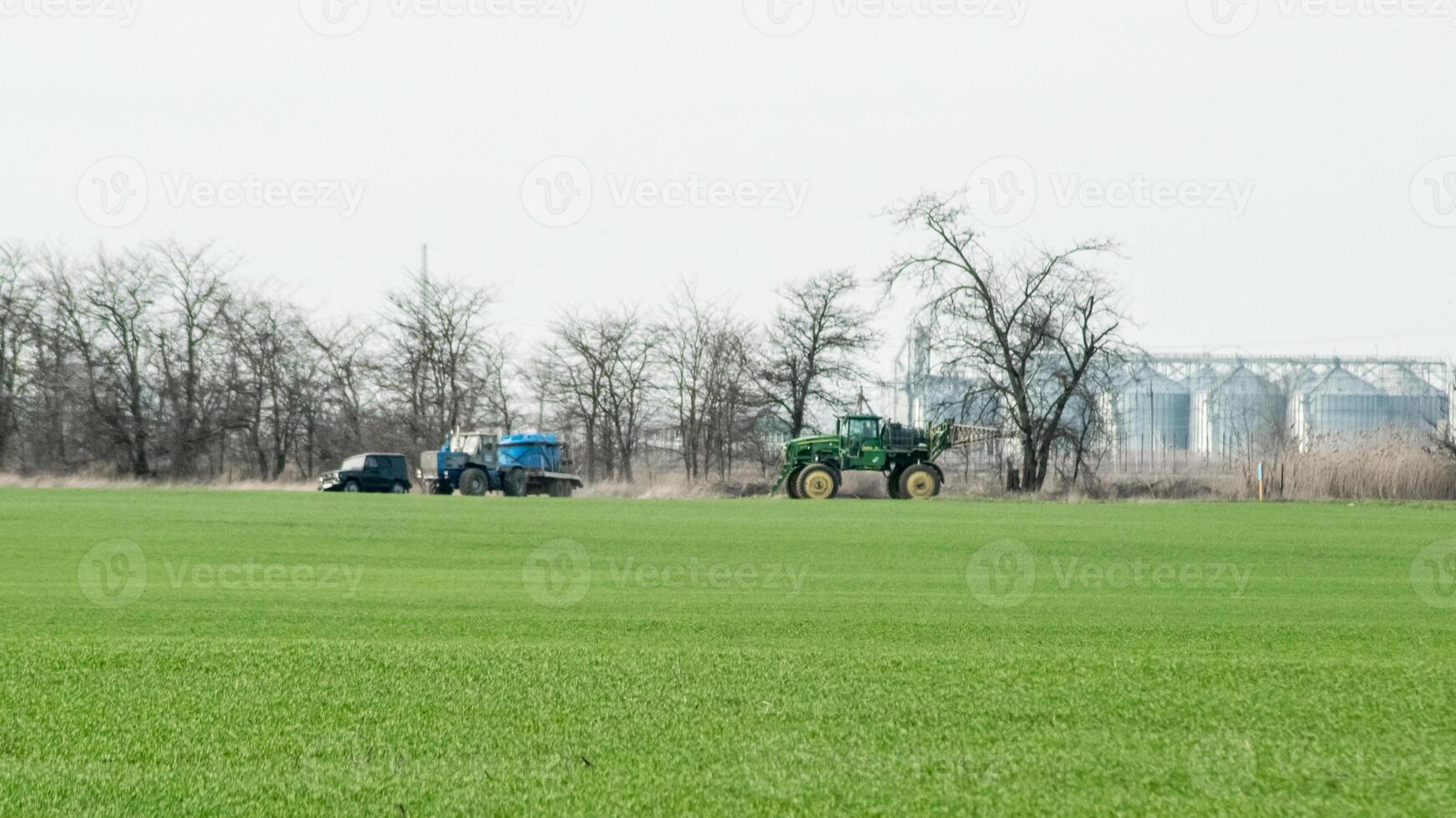 Fertilizing the tractor in the field photo