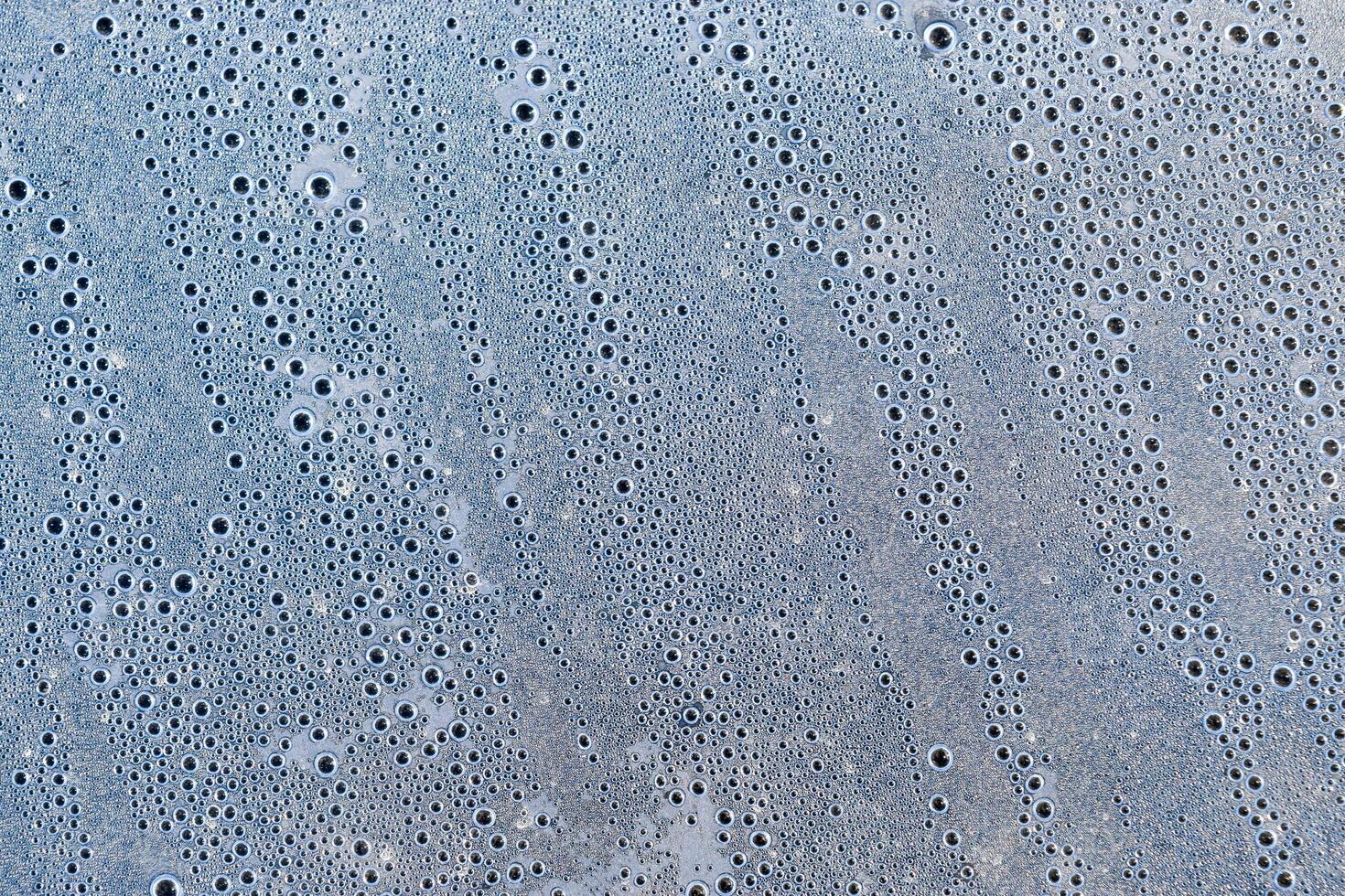 Background of the condensate drops on the film is polyethylene. Water drops texture photo