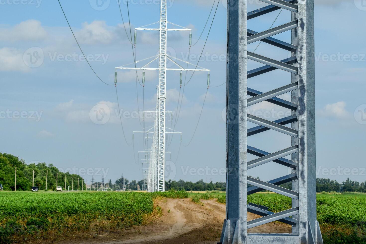 Transmission tower on a background field of soybeans photo