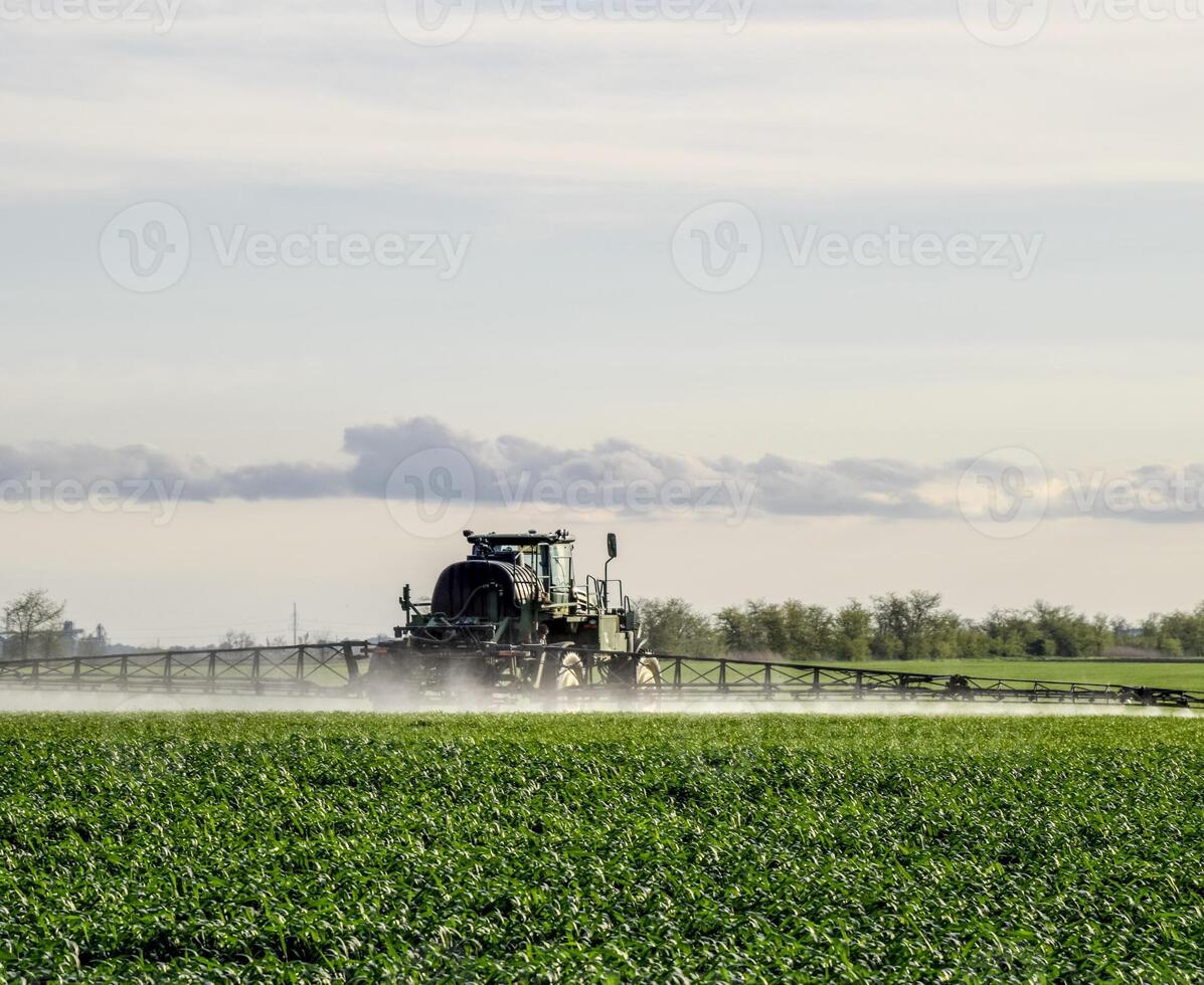 Tractor with a spray device for finely dispersed fertilizer. photo