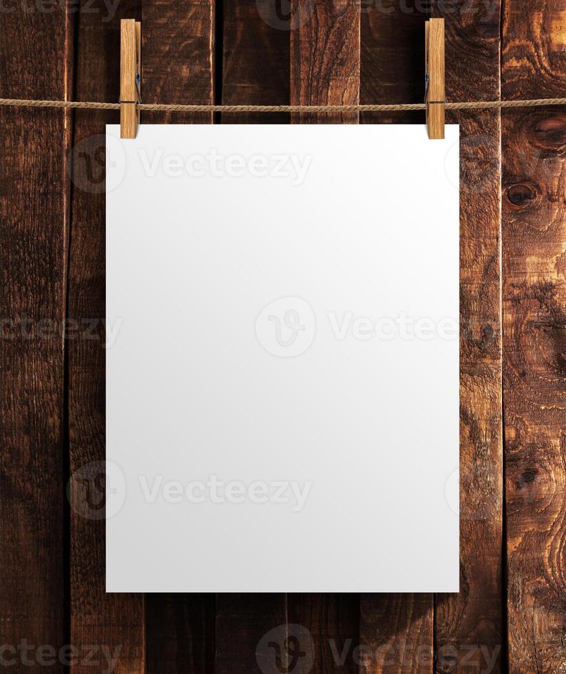 White poster on wooden background. Mock up for your project with copy space photo