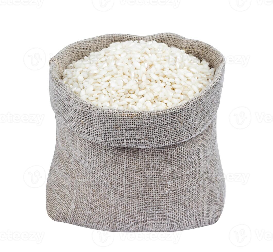 Risotto rice in burlap bag isolated on white photo