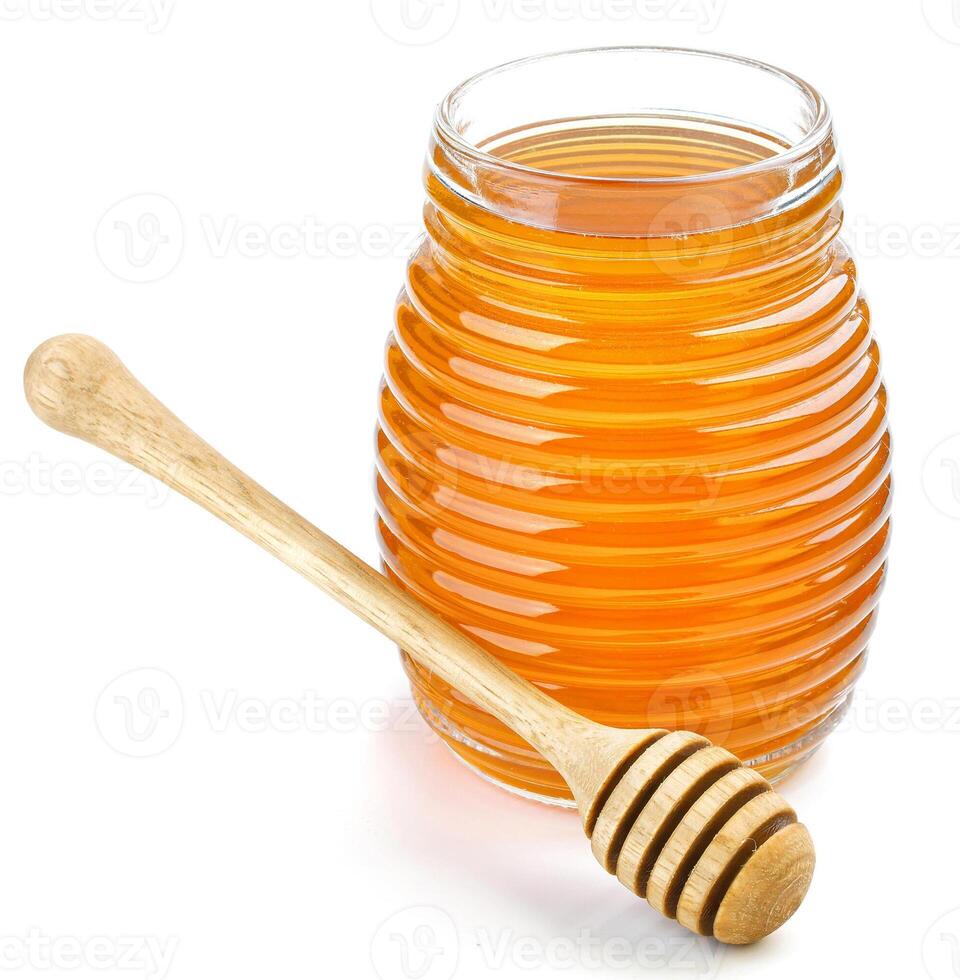 Honey in glass jar isolated on white background photo