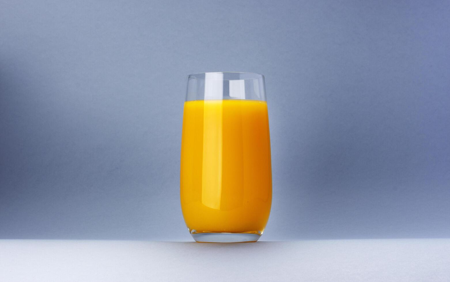Glass of orange juice isolated on white background with copy space photo