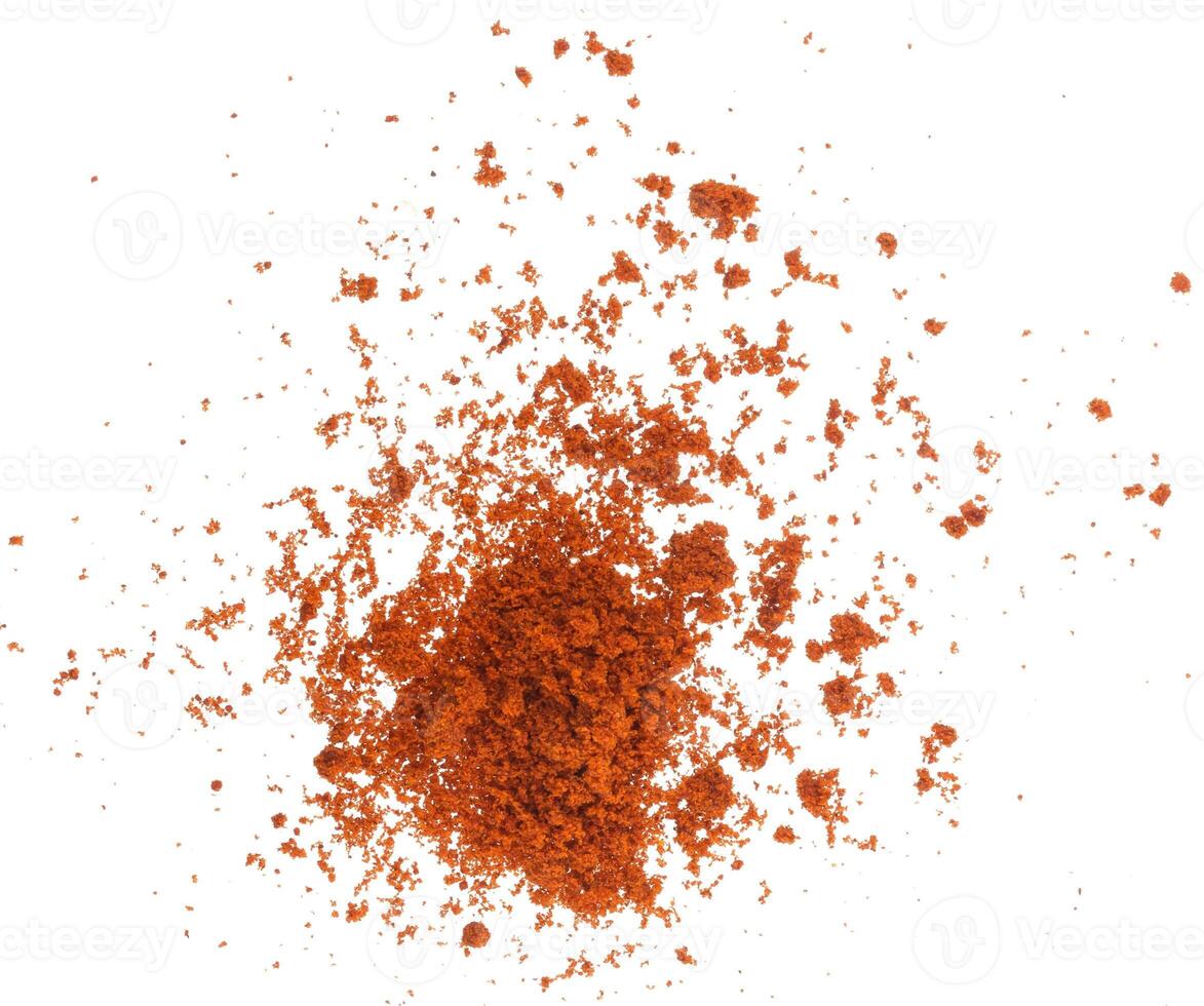 Scattered red paprika powder isolated on white background. Top view photo