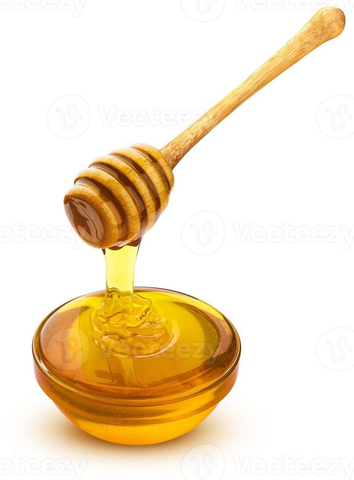 Honey dipper and bowl of pouring honey isolated on white background photo