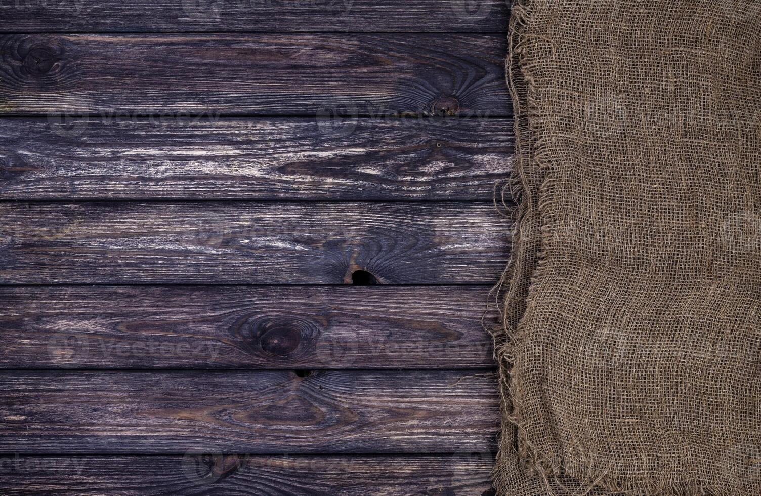 Dark wooden texture with burlap, wood and sack photo