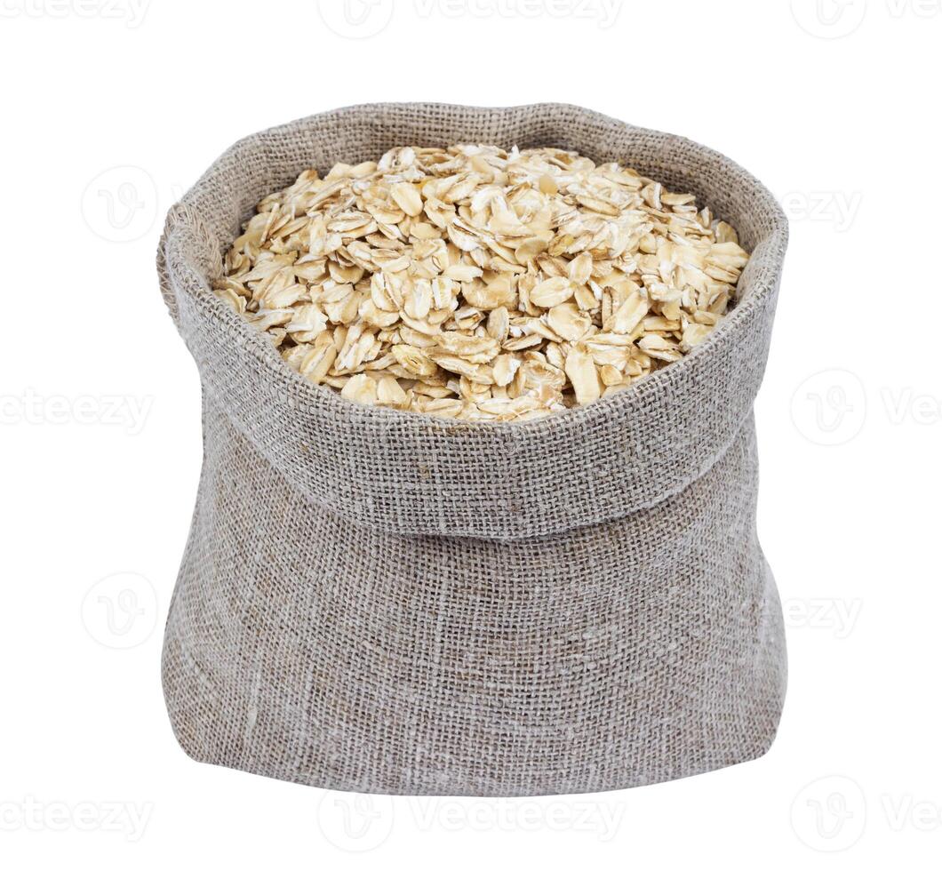 Oat flakes in burlap bag isolated on white photo