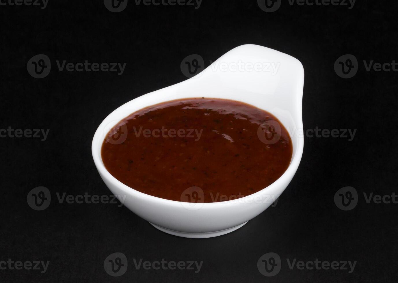 Grill sauce in white bowl isolated on black background photo