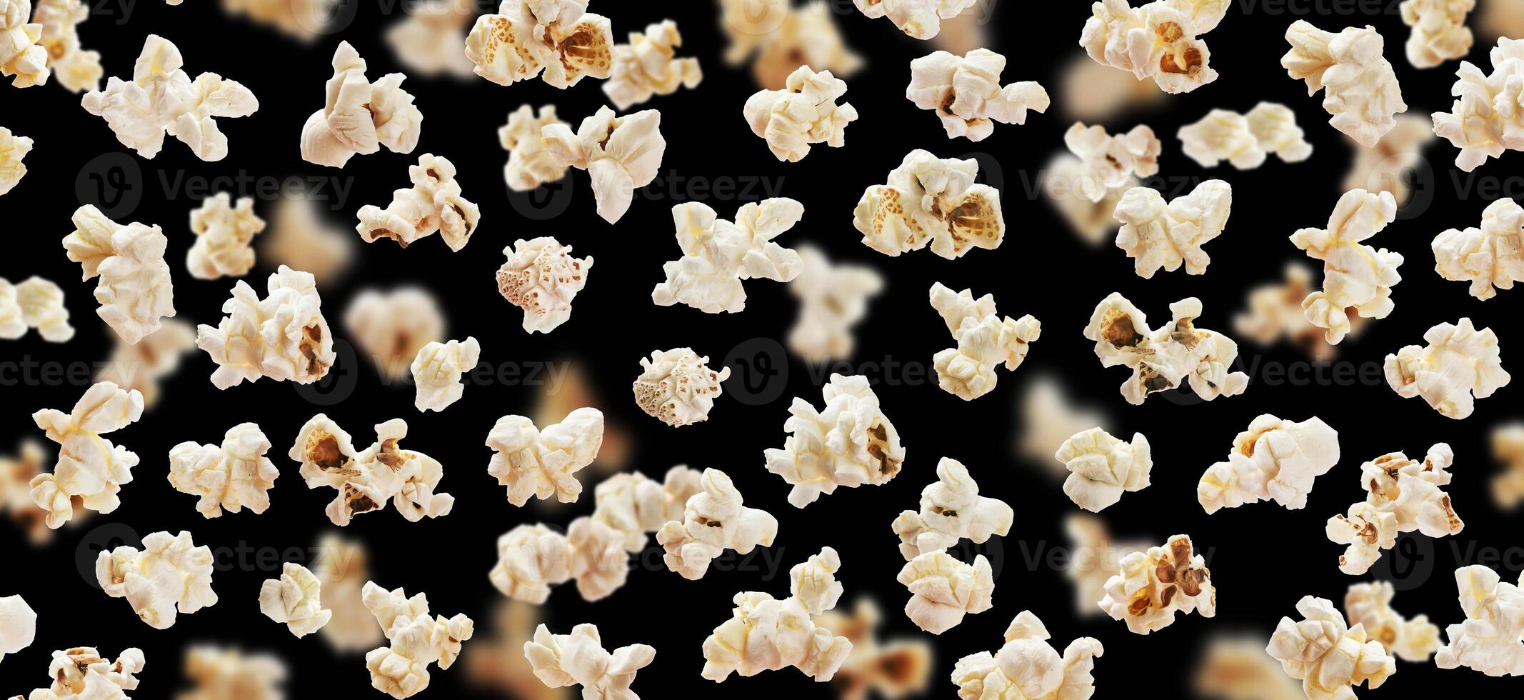 Flying popcorn isolated on black background photo