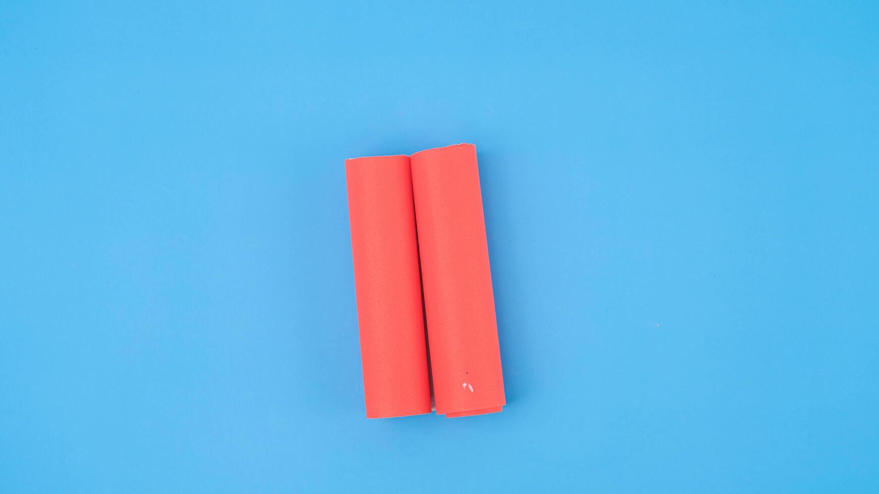An orange rolled square paper is spread out into a blank white sheet on a light blue background. Crumpled blank white paper with copy space for text or advertising space. photo