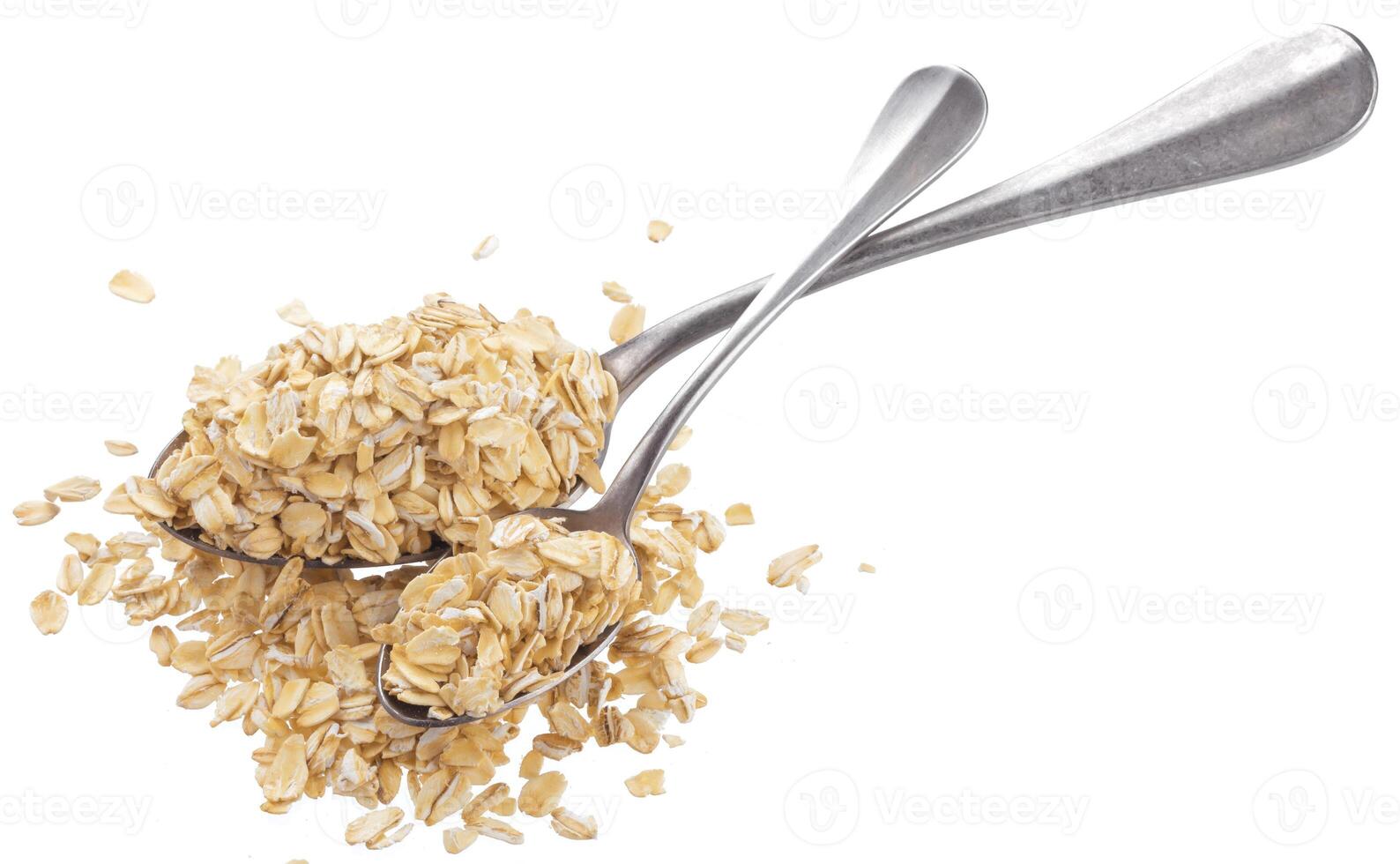 Oat flakes in spoon isolated on white background photo