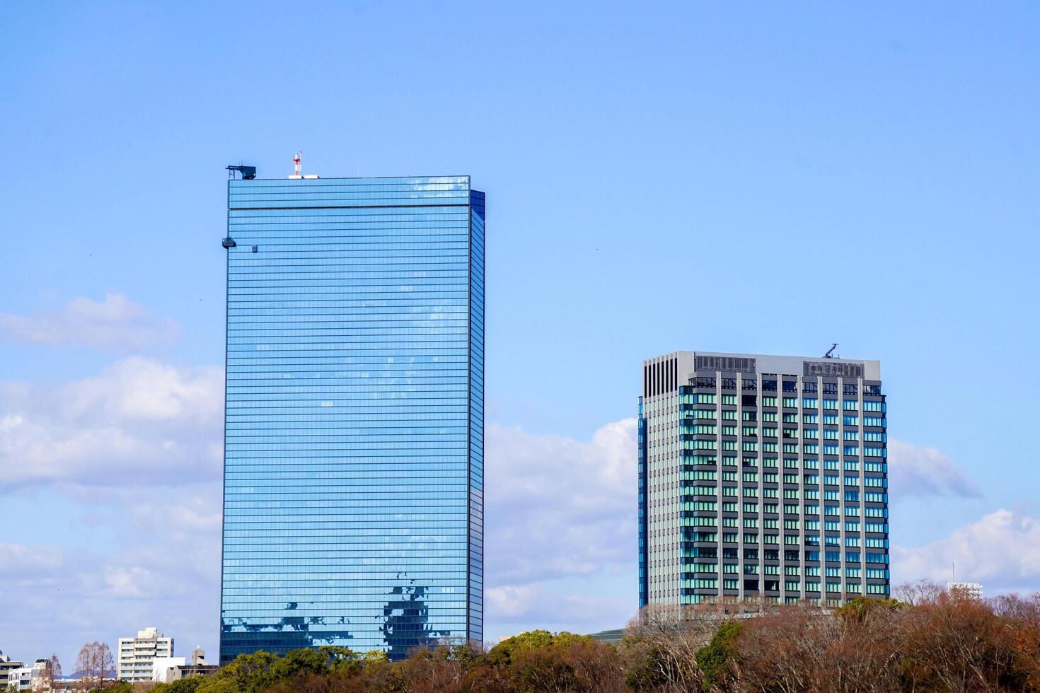Osaka City, Japan, 2023 - Closeup scenery view of glass and office building on blue sky background. photo