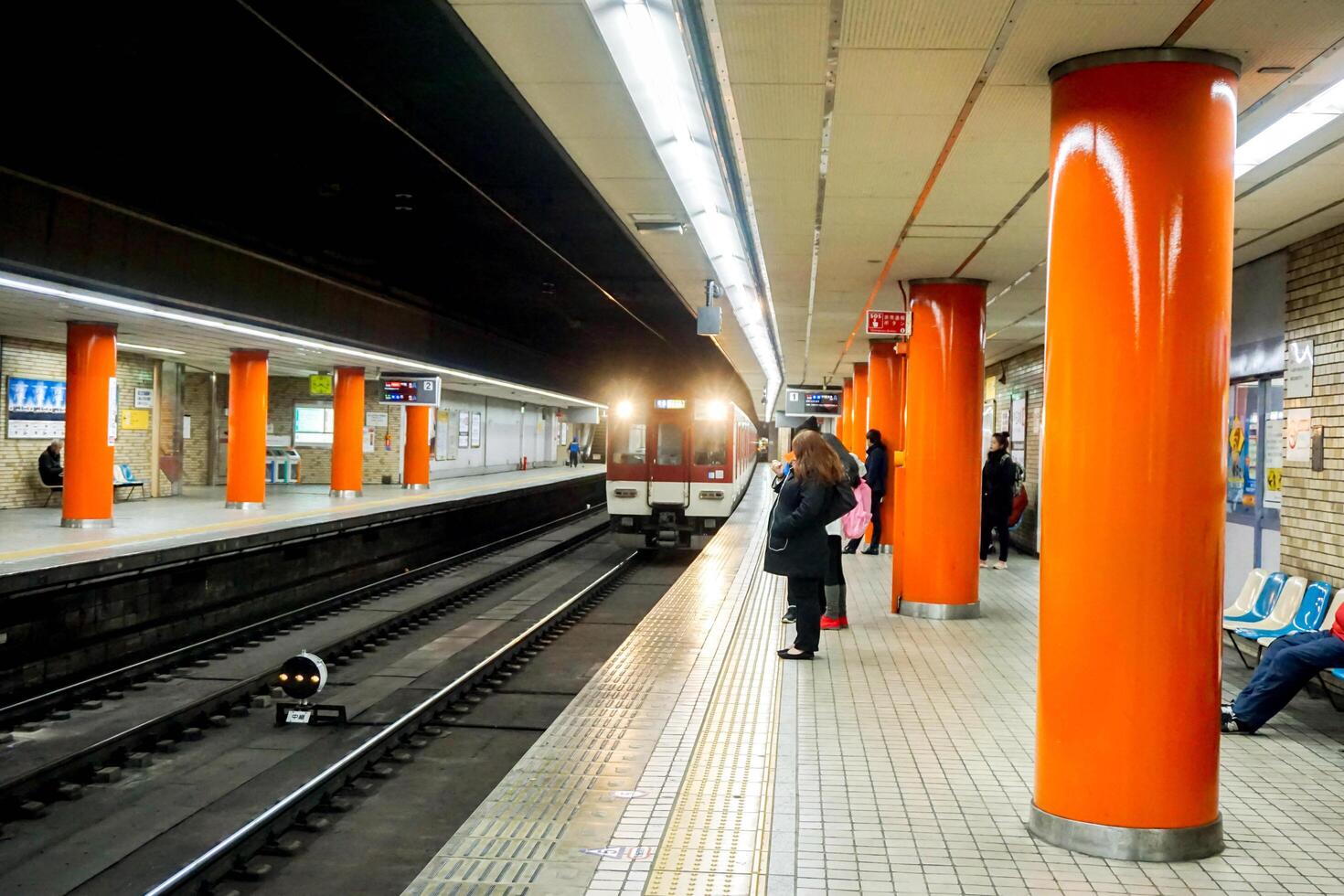 Osaka City, Japan, 2023 - Stop motion image of subway train are arriving station and Japanese people waiting at the subway station of Osaka, Japan. photo