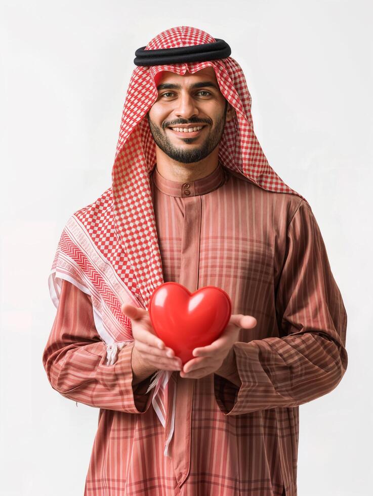 AI generated free photo of a young arabic man weraing traditional clothes holding a red heart in his hands, isolated background