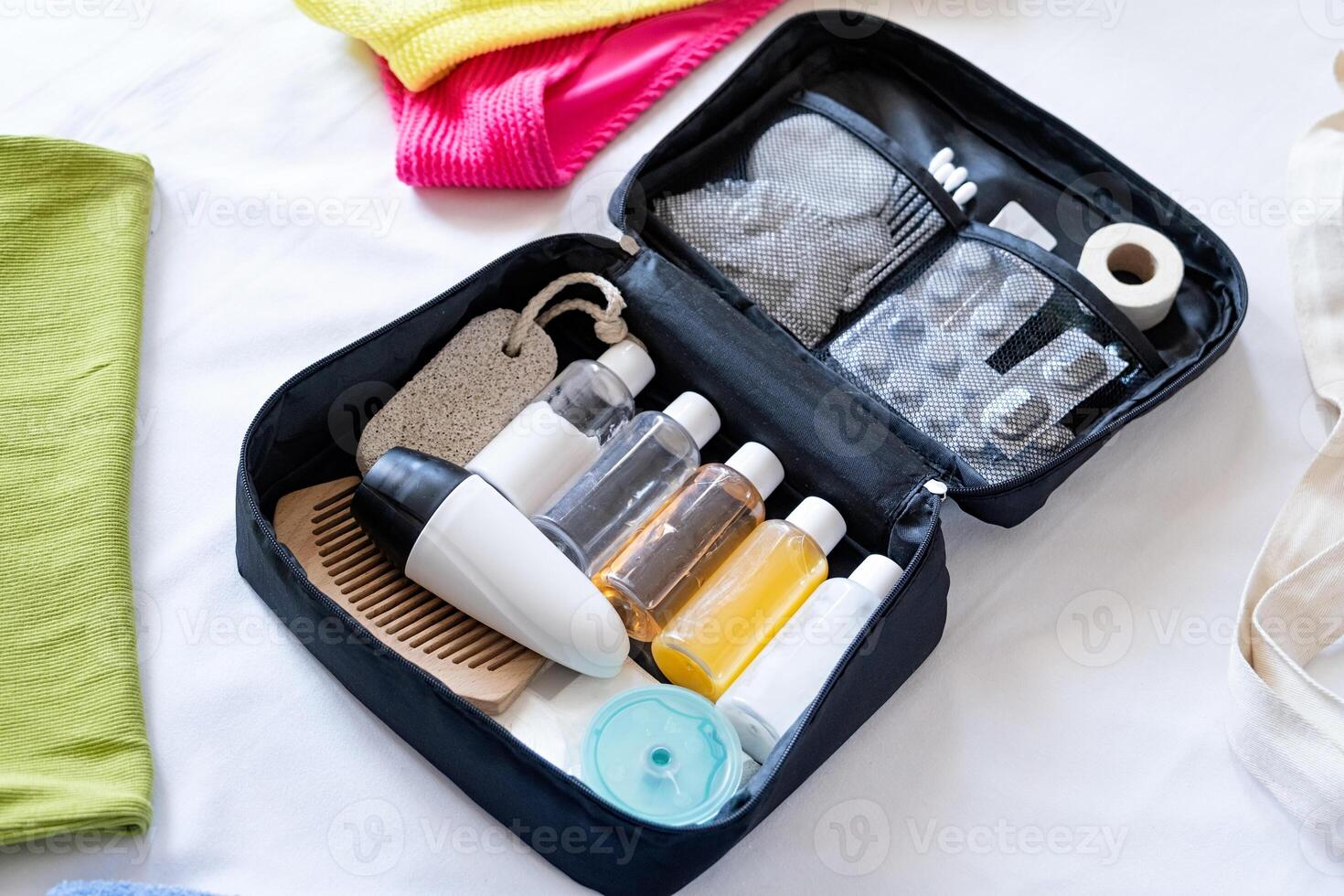 Travel cosmetics kit on bed , top view photo