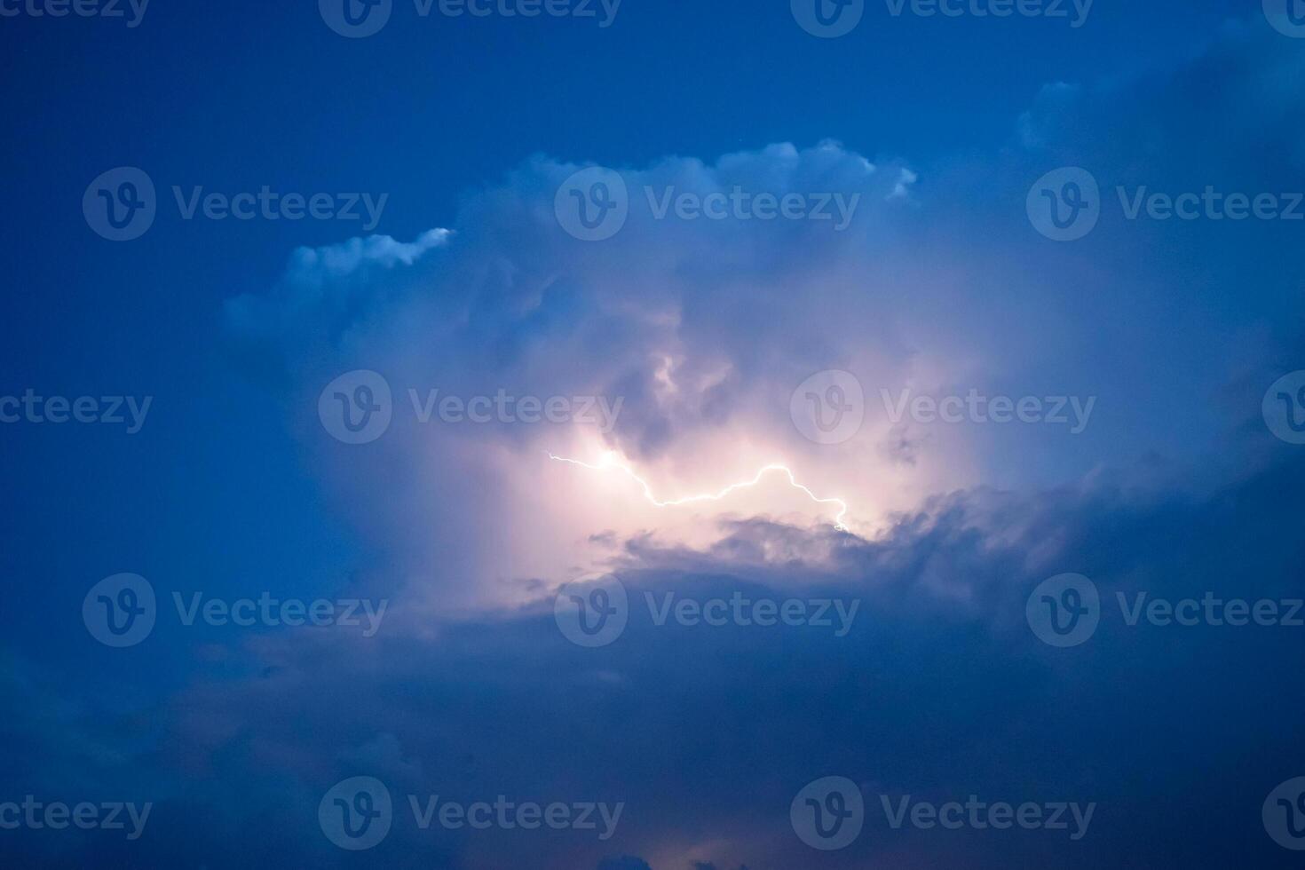 Lightnings in storm clouds. Peals of a thunder and the sparkling lightnings in clouds photo