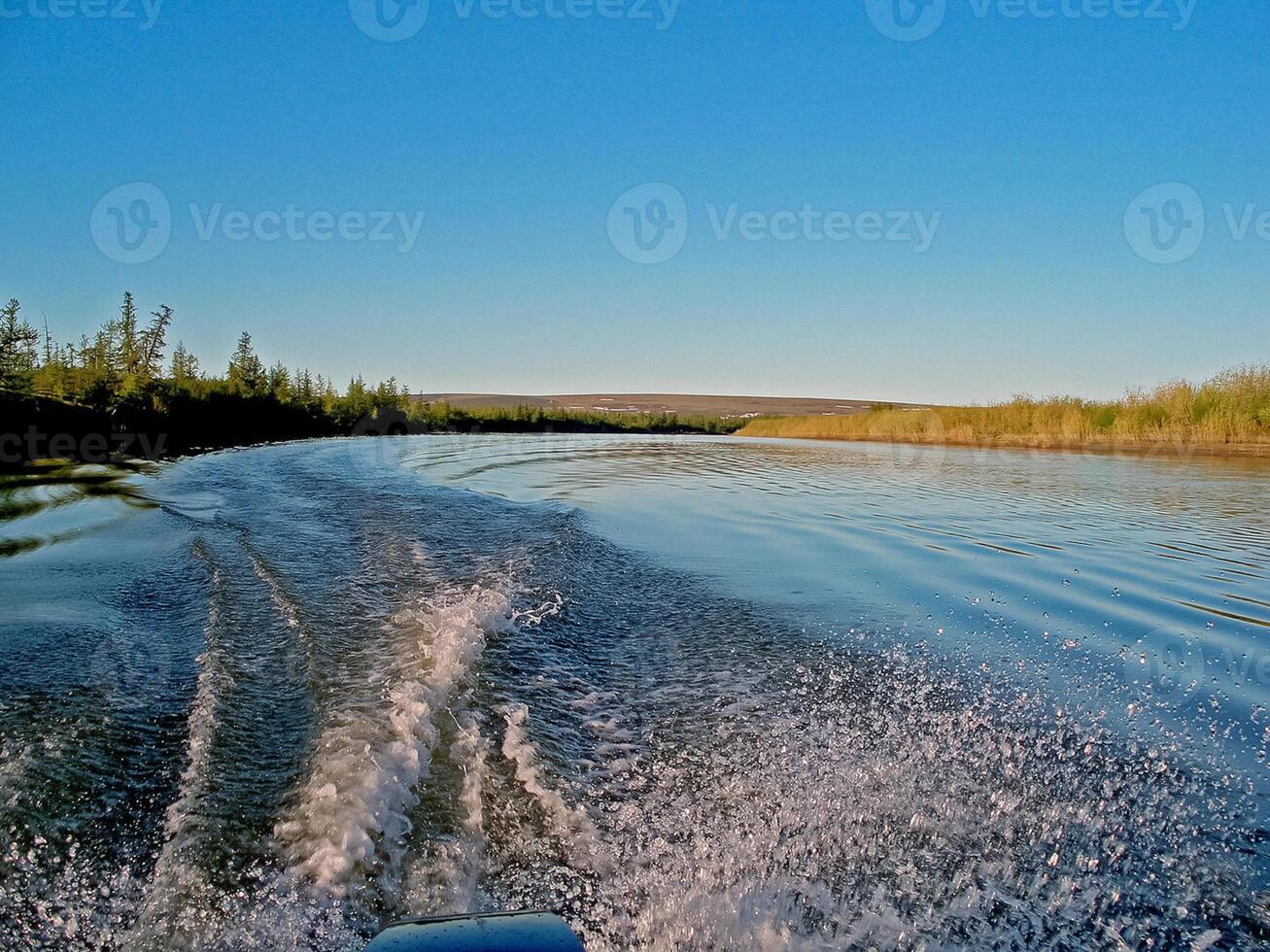 Waters of water from a motor boat in the river. photo