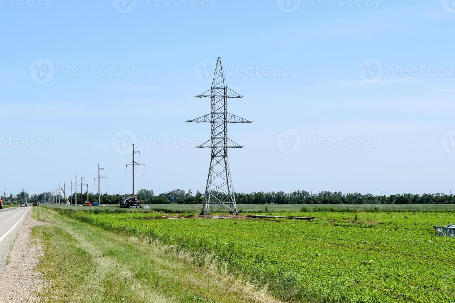 Transmission tower on a background field of soybeans photo