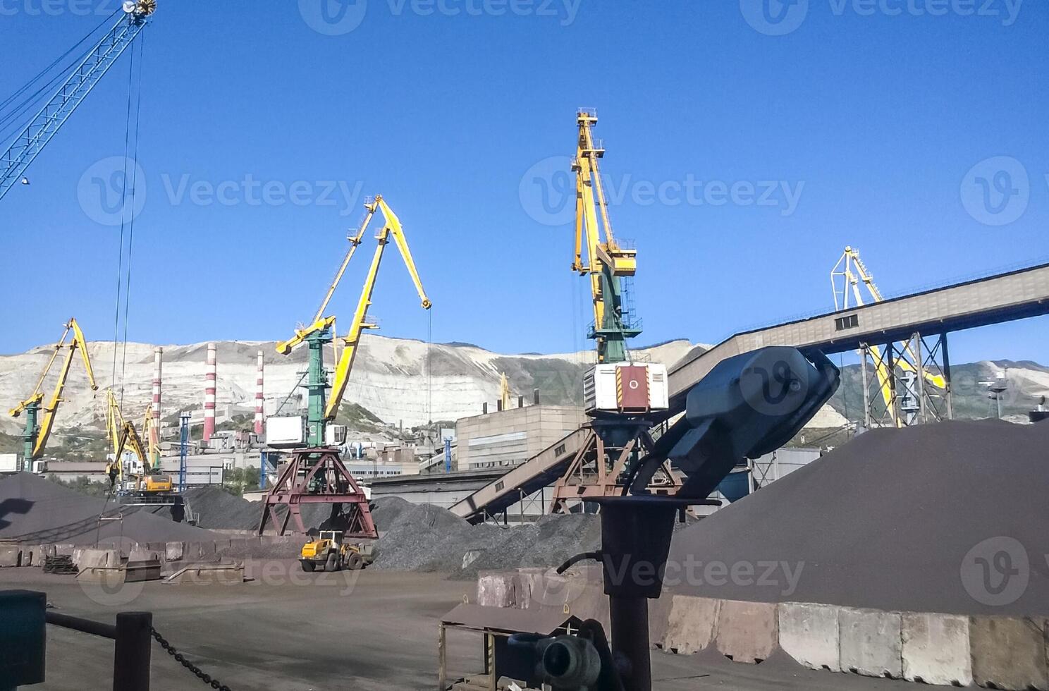 Cargo industrial port, port cranes. Loading of anthracite. Transportation of coal. Heap of coal photo