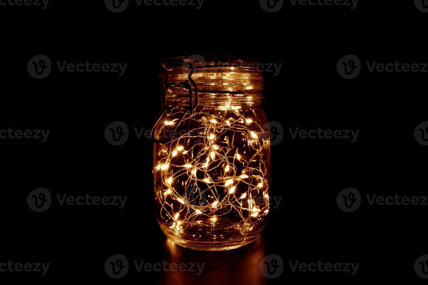 Warm Fairy Light in a Glass Jar, in the Dark, Low-Key Photography photo