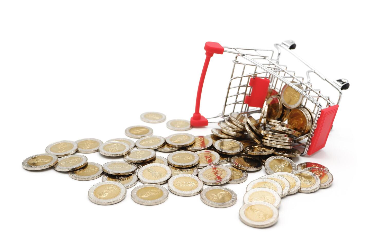 Red miniature shopping cart filled with new 10 Thai Baht coins, isolated on white background. Business concept. photo