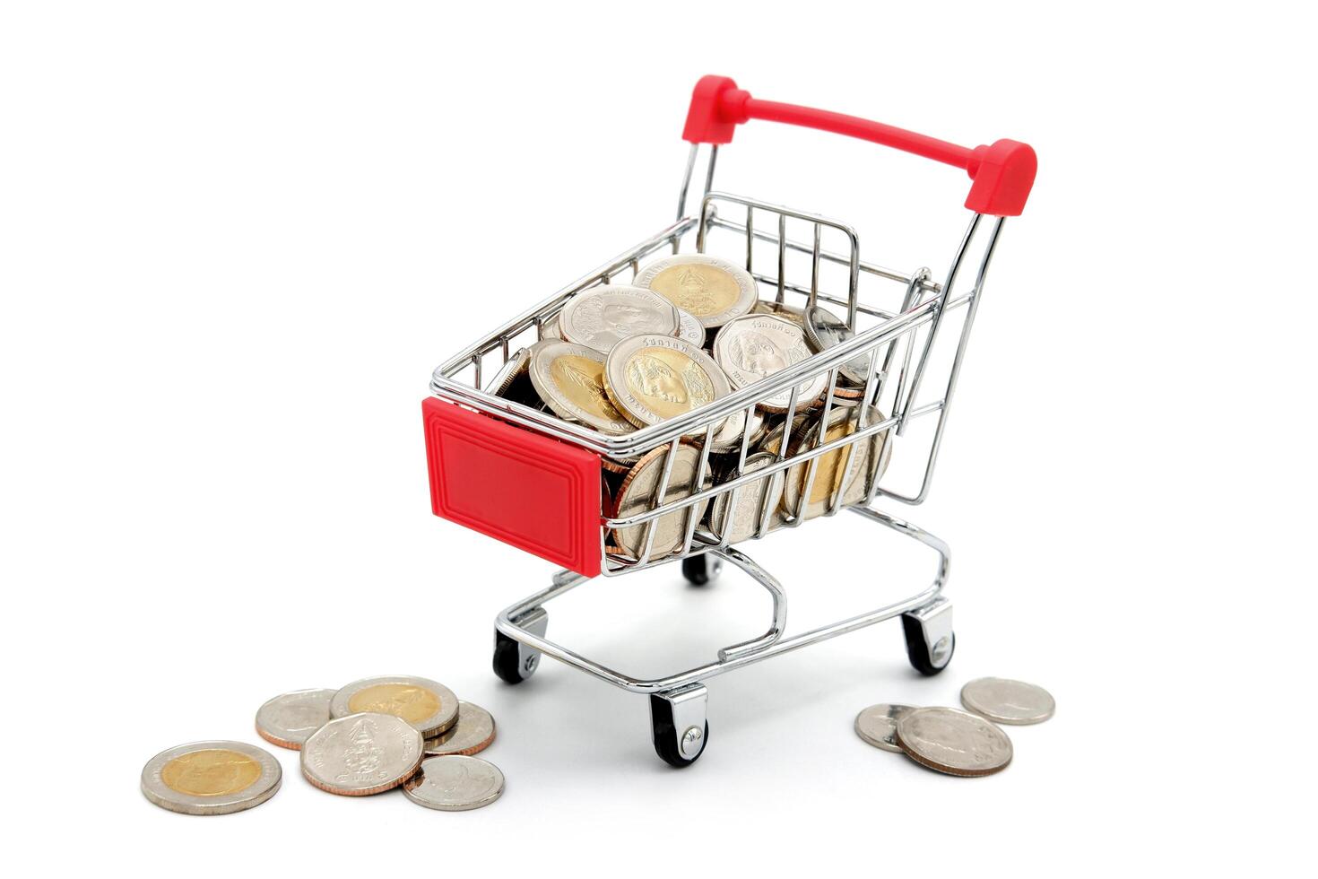 New Thai Baht coins in red miniature shopping cart. Business and finance concept. photo