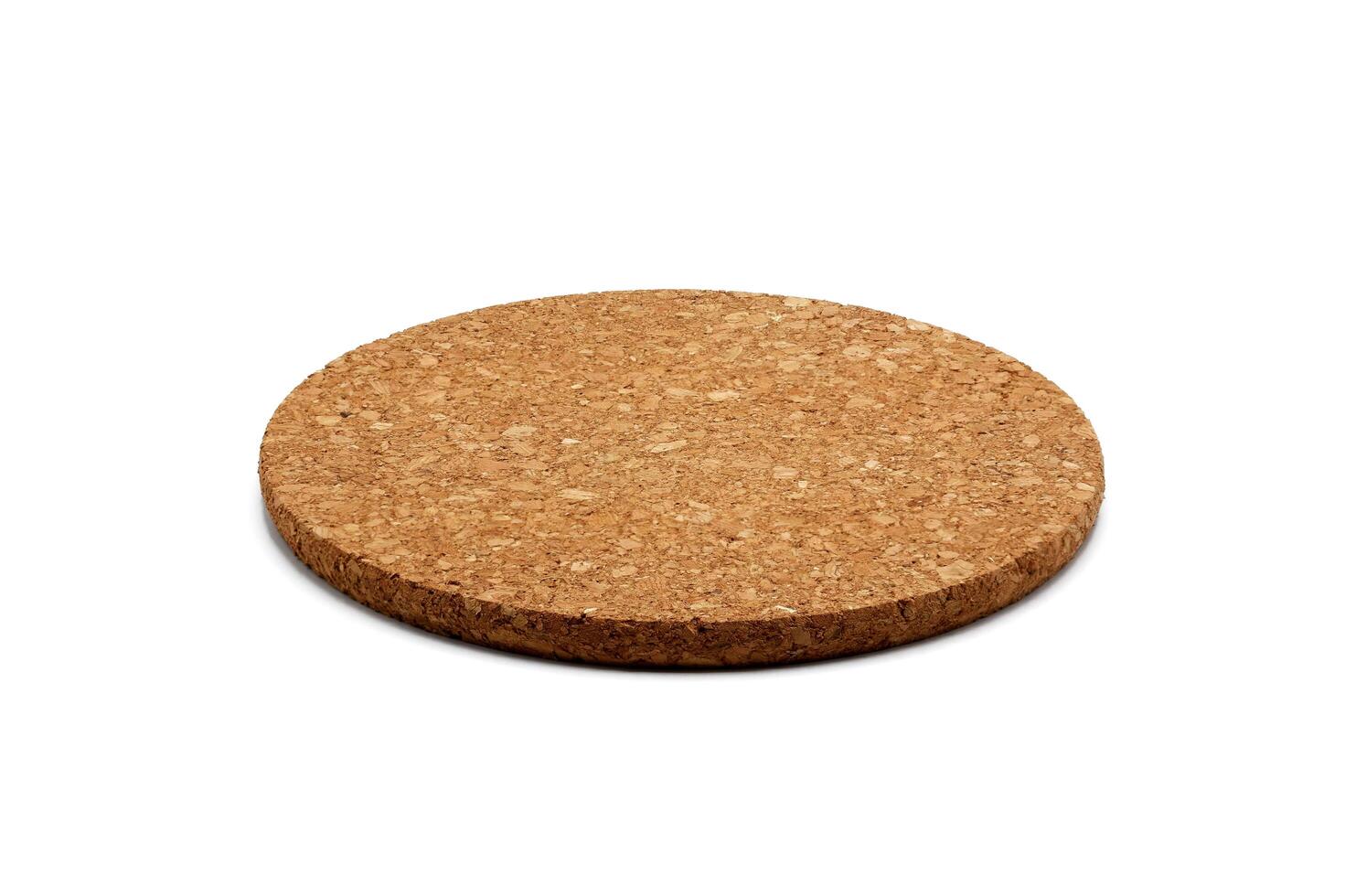 Empty round cork coaster, isolated on white background. photo