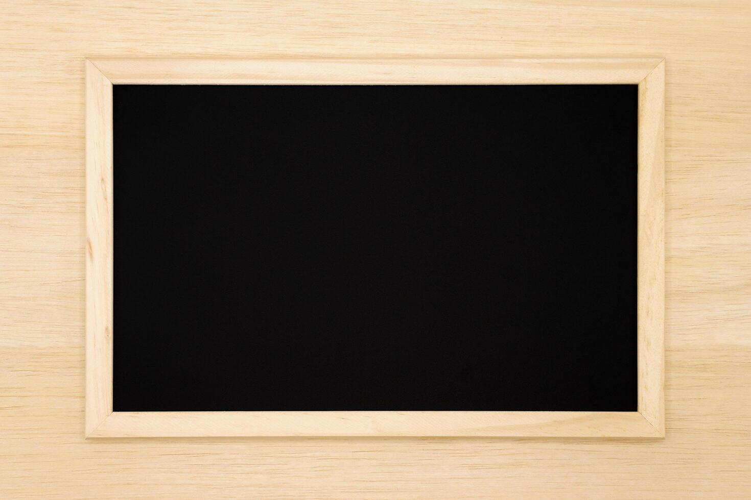 Blank chalkboard on wooden background. photo