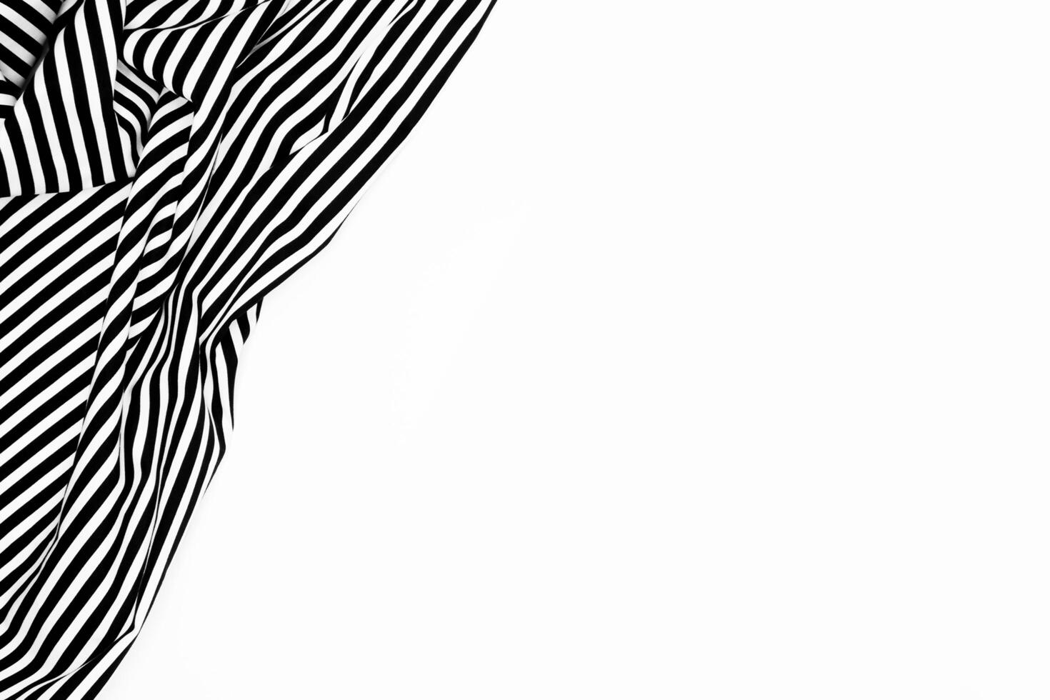 Wrinkled black and white striped fabric isolated on white background photo