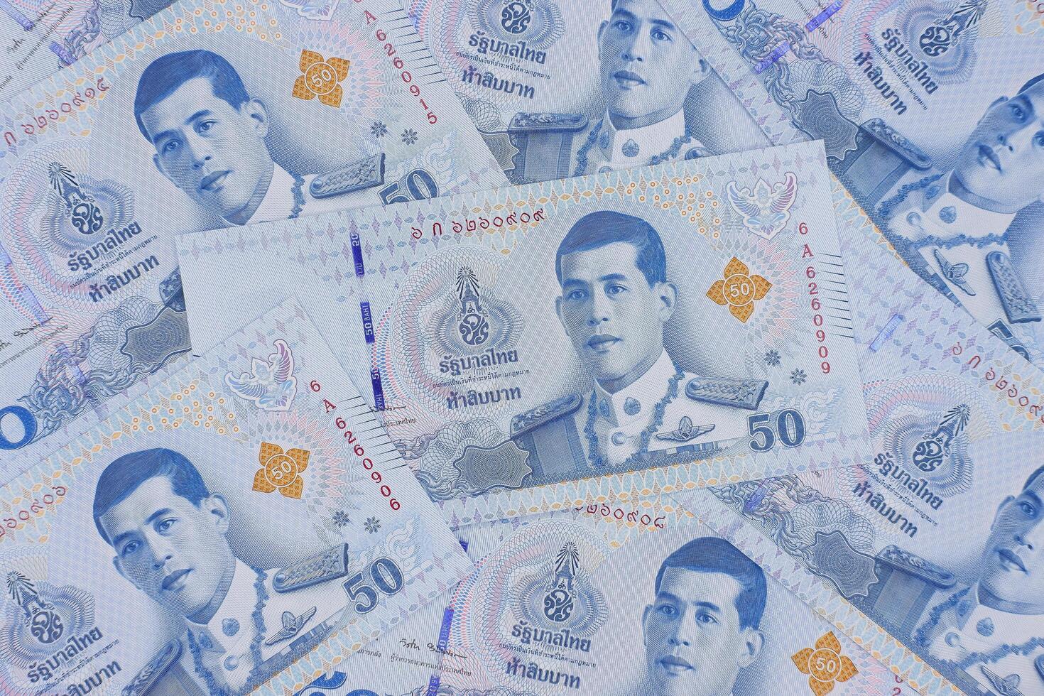 Pile of new 50 Thai Baht banknotes. Business and finance concept. photo