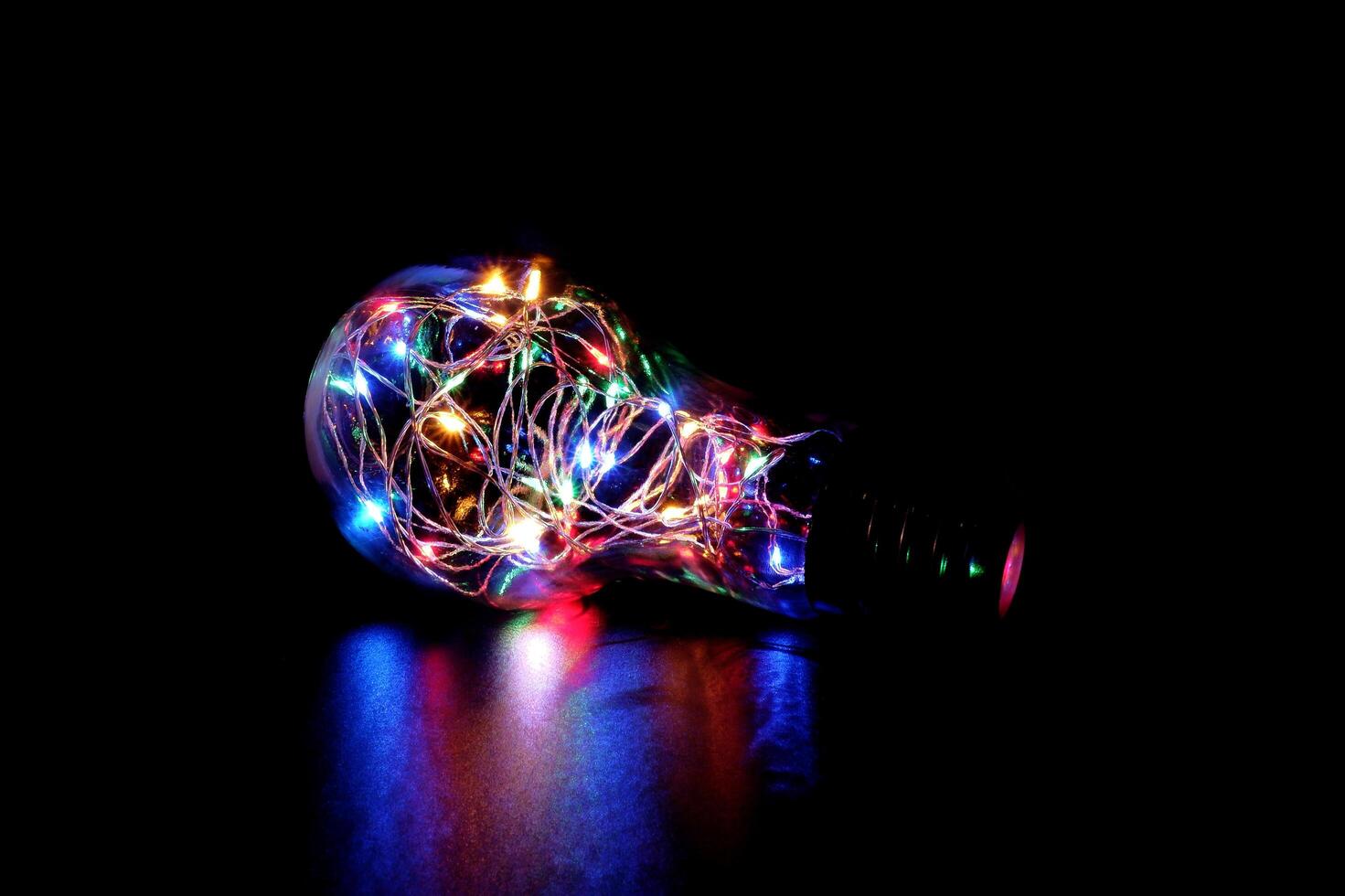 Colorful Fairy Light in a Glass Jar, in the Dark, Low-Key Photography photo