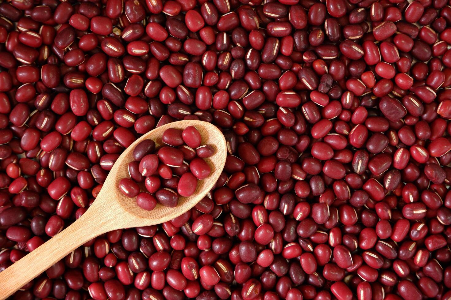 Red Beans Background with Wooden Spoon photo