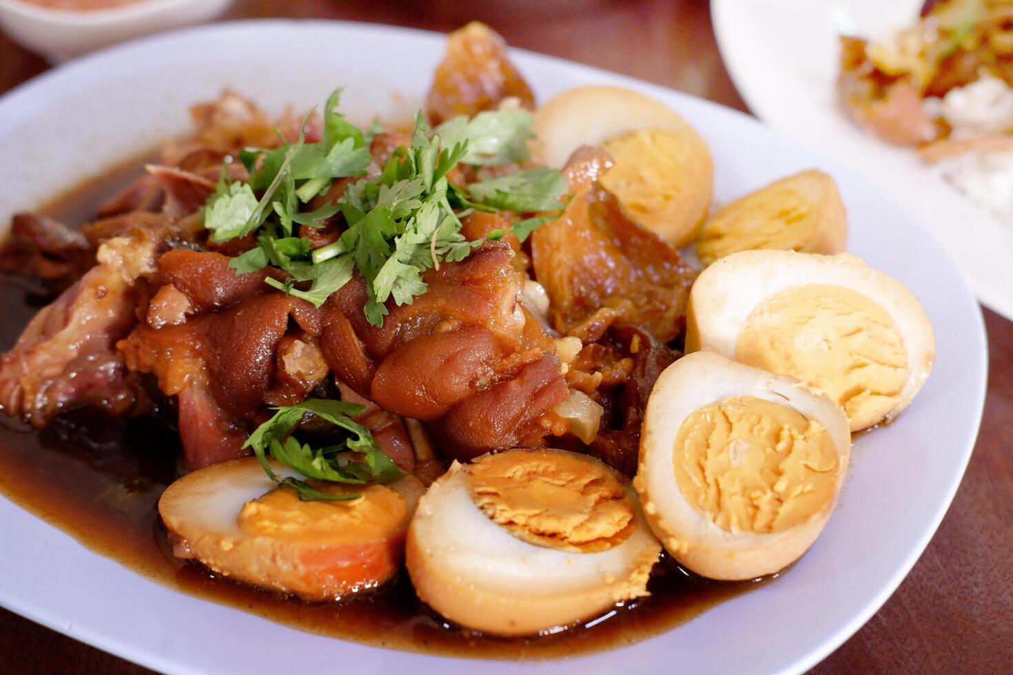 Thai styled braised pork leg with boiled eggs. photo