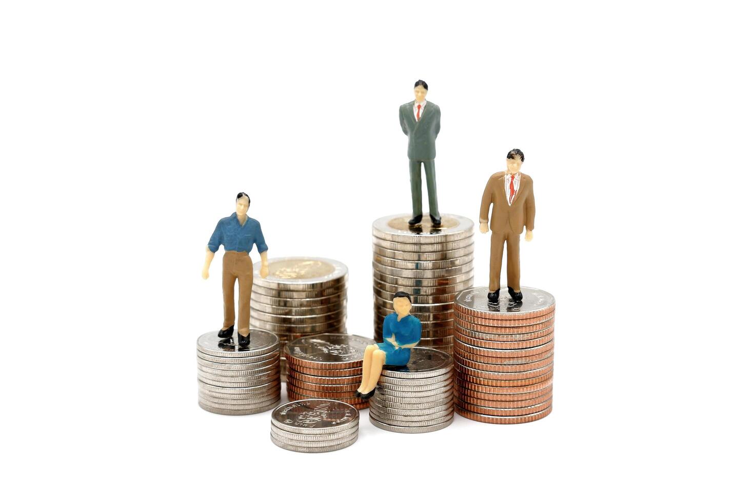 Miniature people on stack of new Thai Baht coins, isolated on white background. Business and finance concept. photo