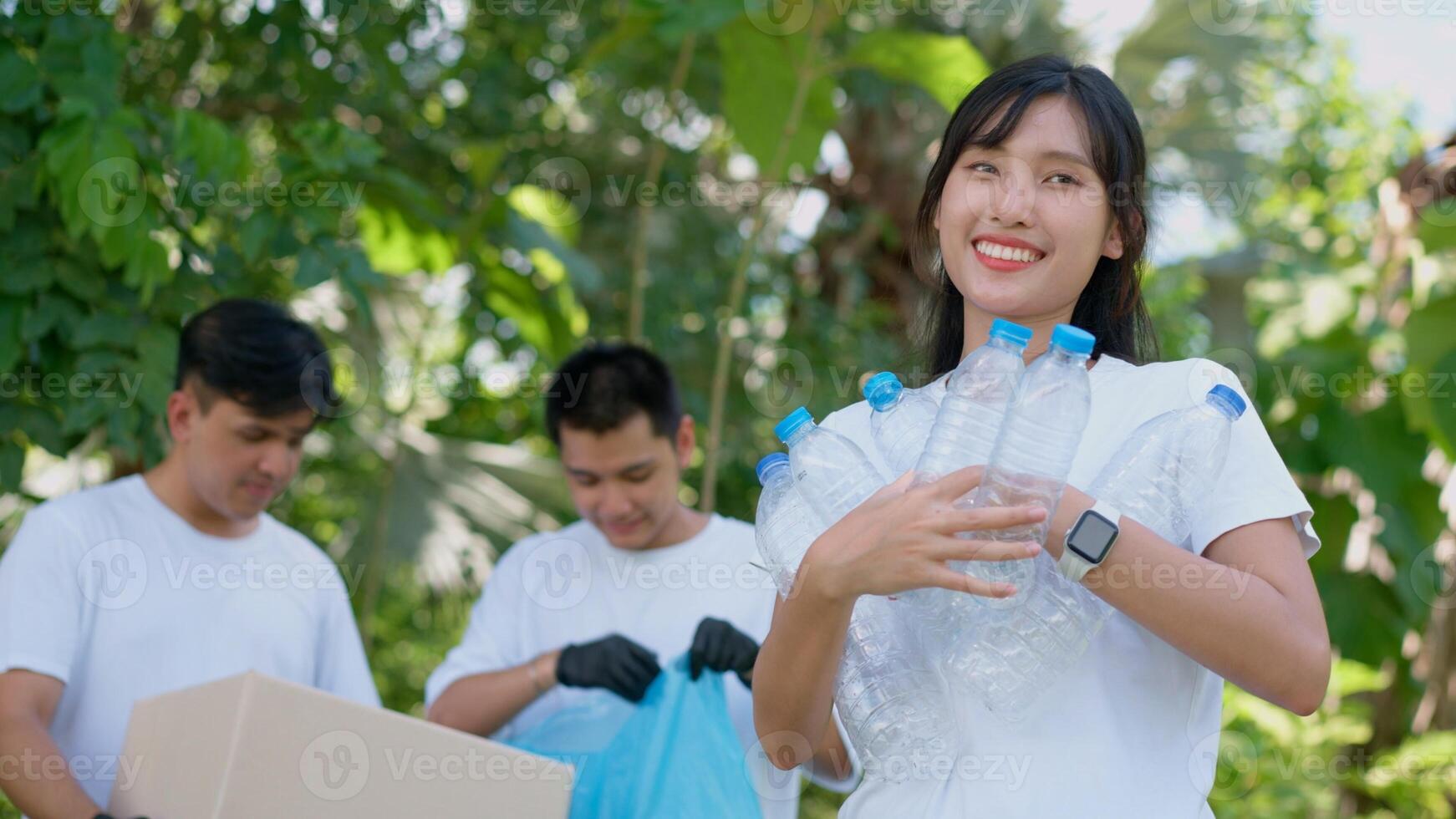 Happy young Asian students diverse volunteers with garbage bags cleaning area in the park, The concept of environmental conservation on world environment day, recycling, charity for sustainability. photo